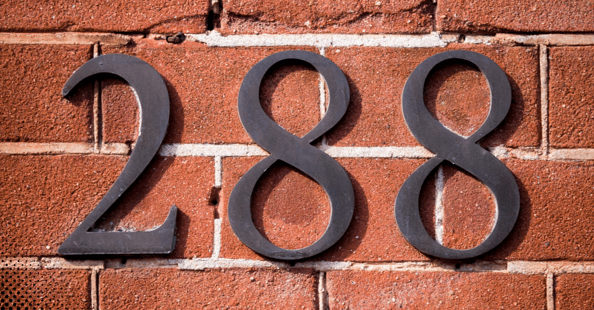 House number 288 in black metal on a red brick wall