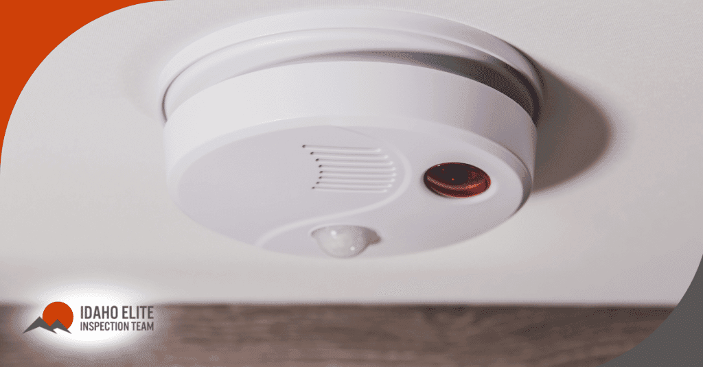 A close-up of a smoke and carbon monoxide detector on the ceiling