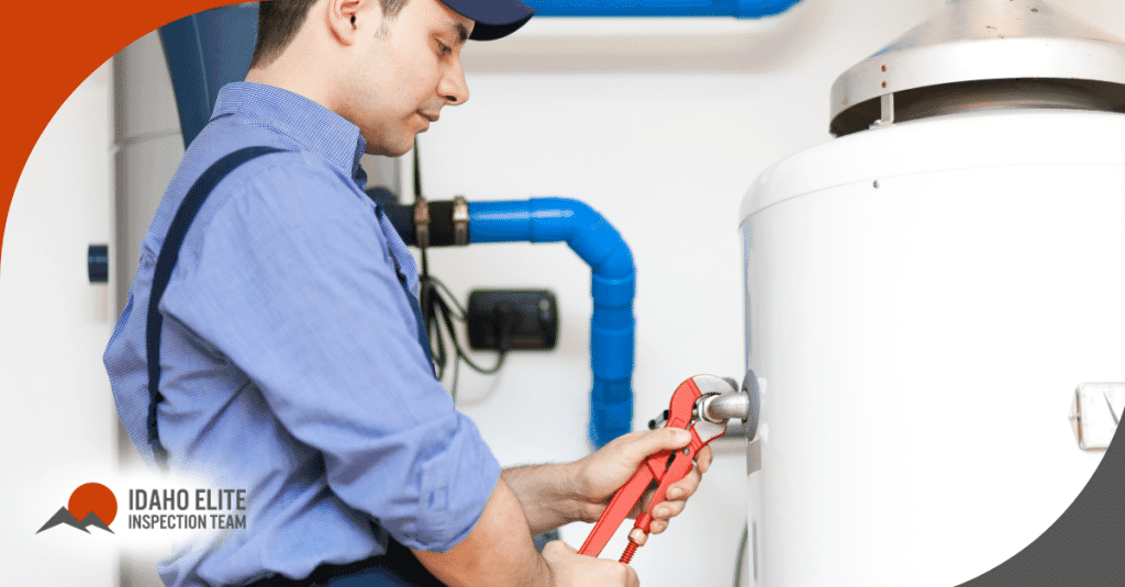 Technician tightening a water heater connection with a wrench.