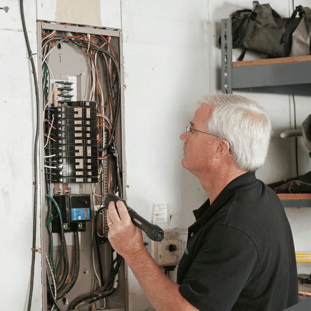 Home inspector examining electrical panel