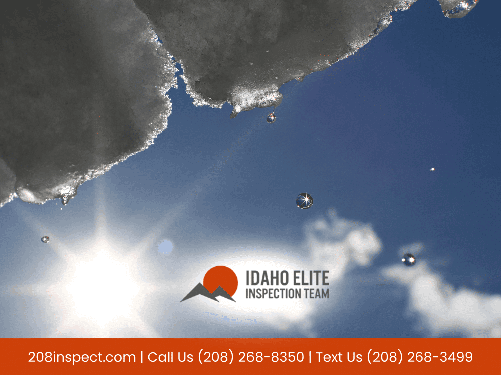 Snow melting under the sunlight with droplets falling.